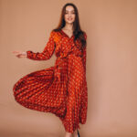 Young woman in a beautiful red dress in studio